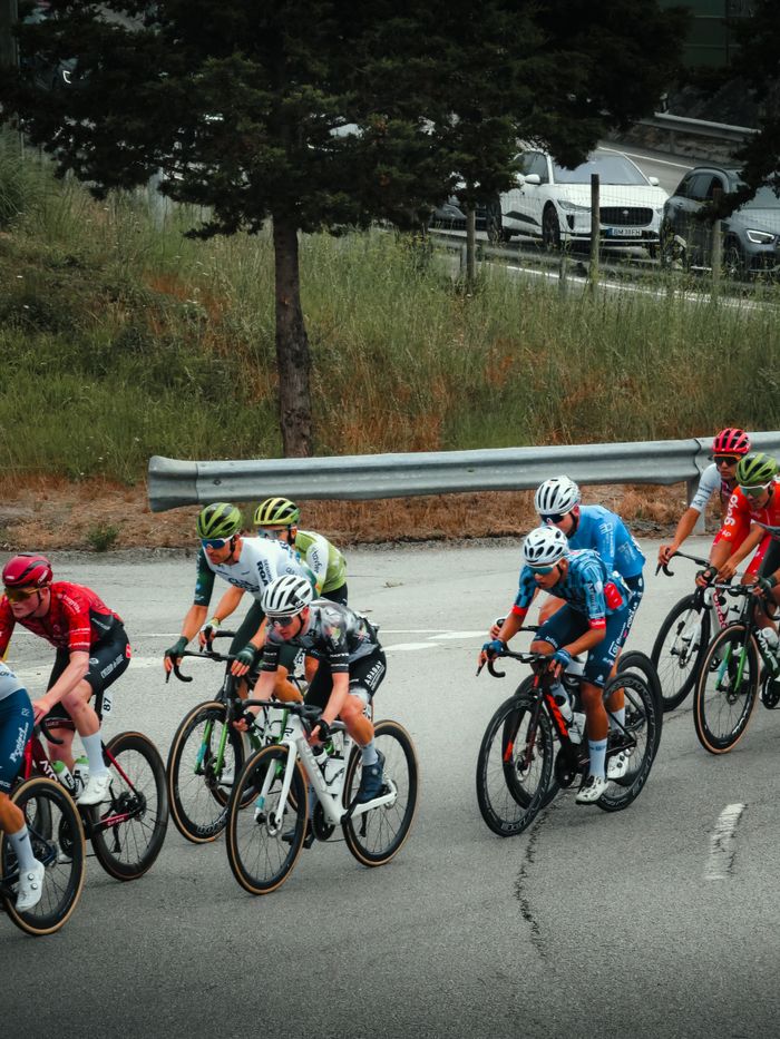 Cyclists race through Portugal during a competitive event, showcasing their skills.